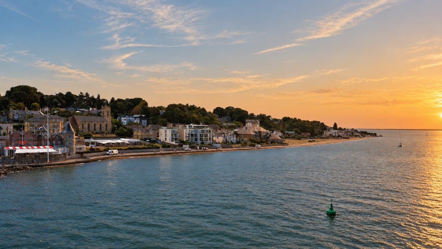 Cowes seafront seen from the water at sunset